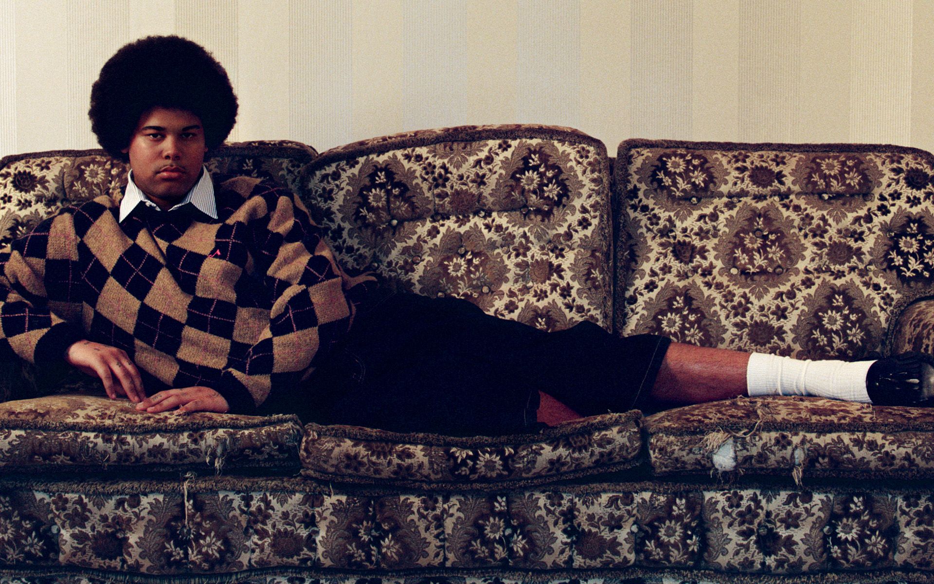 Sekou lying horizontally on a sofa